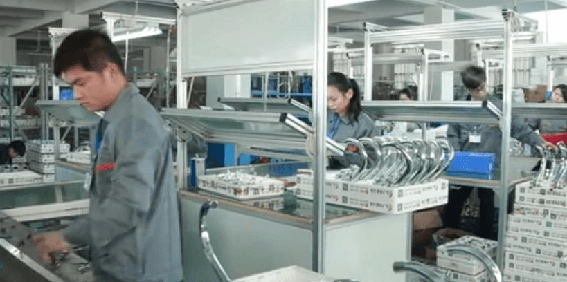 Workers on the FYASSI faucet assembly line