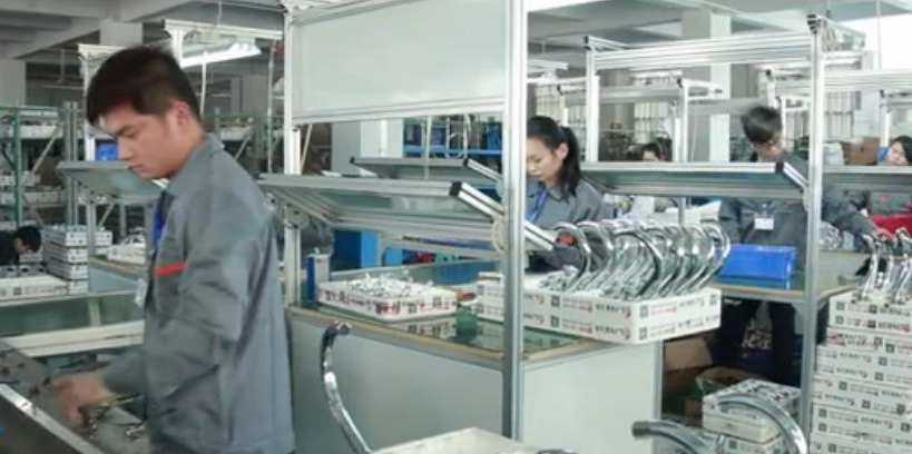 Workers on the FYASSI faucet assembly line